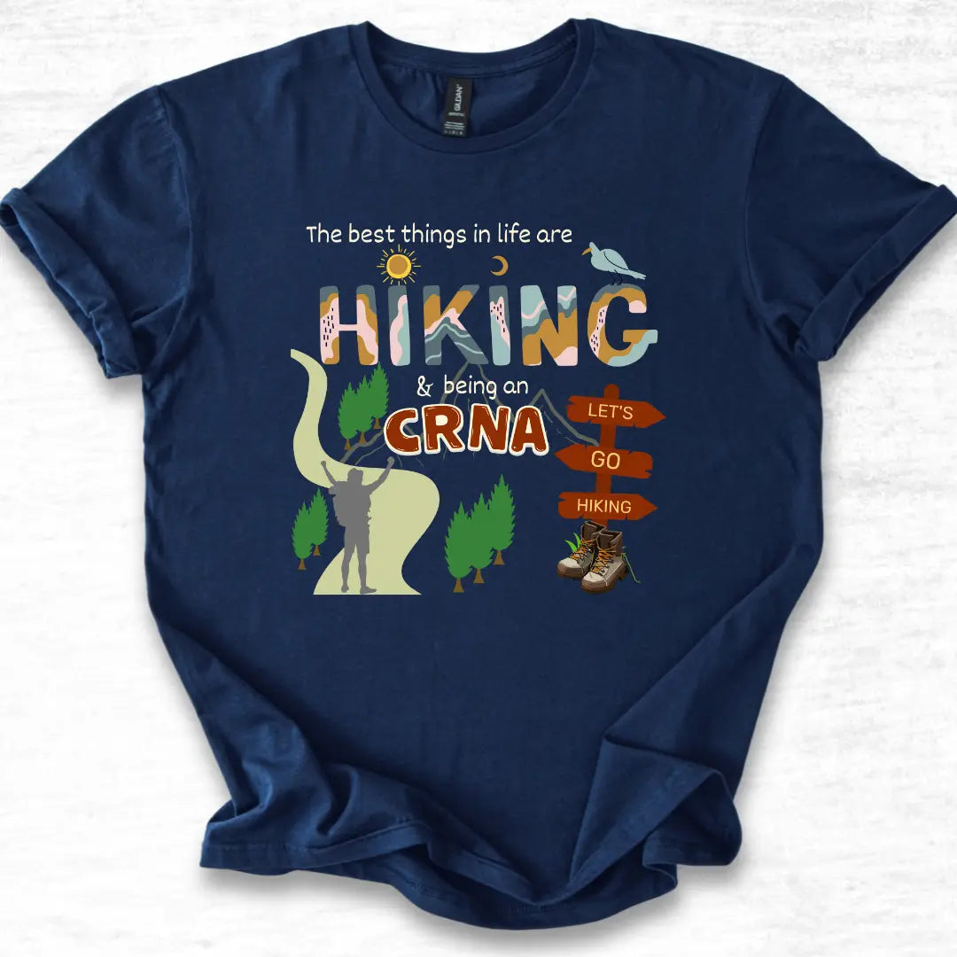 Navy blue t-shirt with hiking-themed design and 'CRNA' text on a light gray background