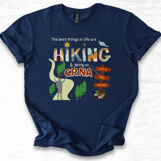 Navy blue t-shirt with hiking-themed design and 'CRNA' text on a light gray background