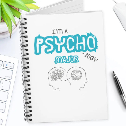 Notebook with 'I'm a Psychology Major' design on a desk with a pen and plant.