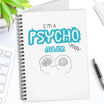 Notebook with 'I'm a Psychology Major' design on a desk with a pen and plant.