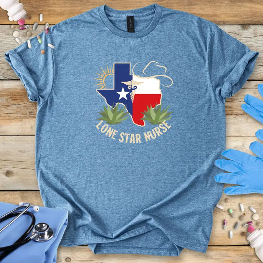 Blue t-shirt with 'Lone Star Nurse' design on a wooden surface with medical supplies.