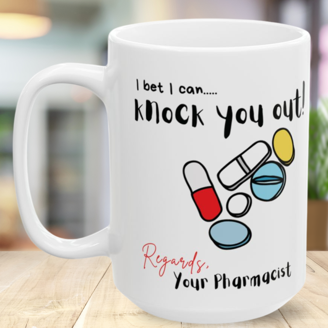 White mug with colorful pill graphics and 'I bet I can knock you out' text on a wooden surface