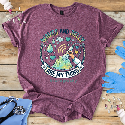 Maroon t-shirt with 'Waves and Jelly are my thing #sonography' design on a wooden surface with medical items.
