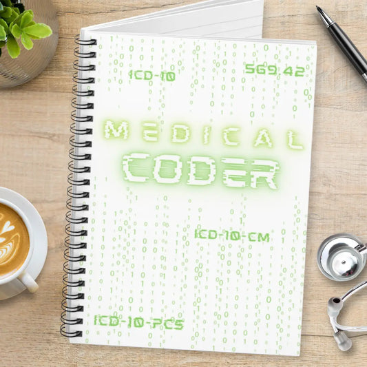 Medical coder notebook with text 'Medical Coder' on a desk with a cup of coffee and stethoscope.