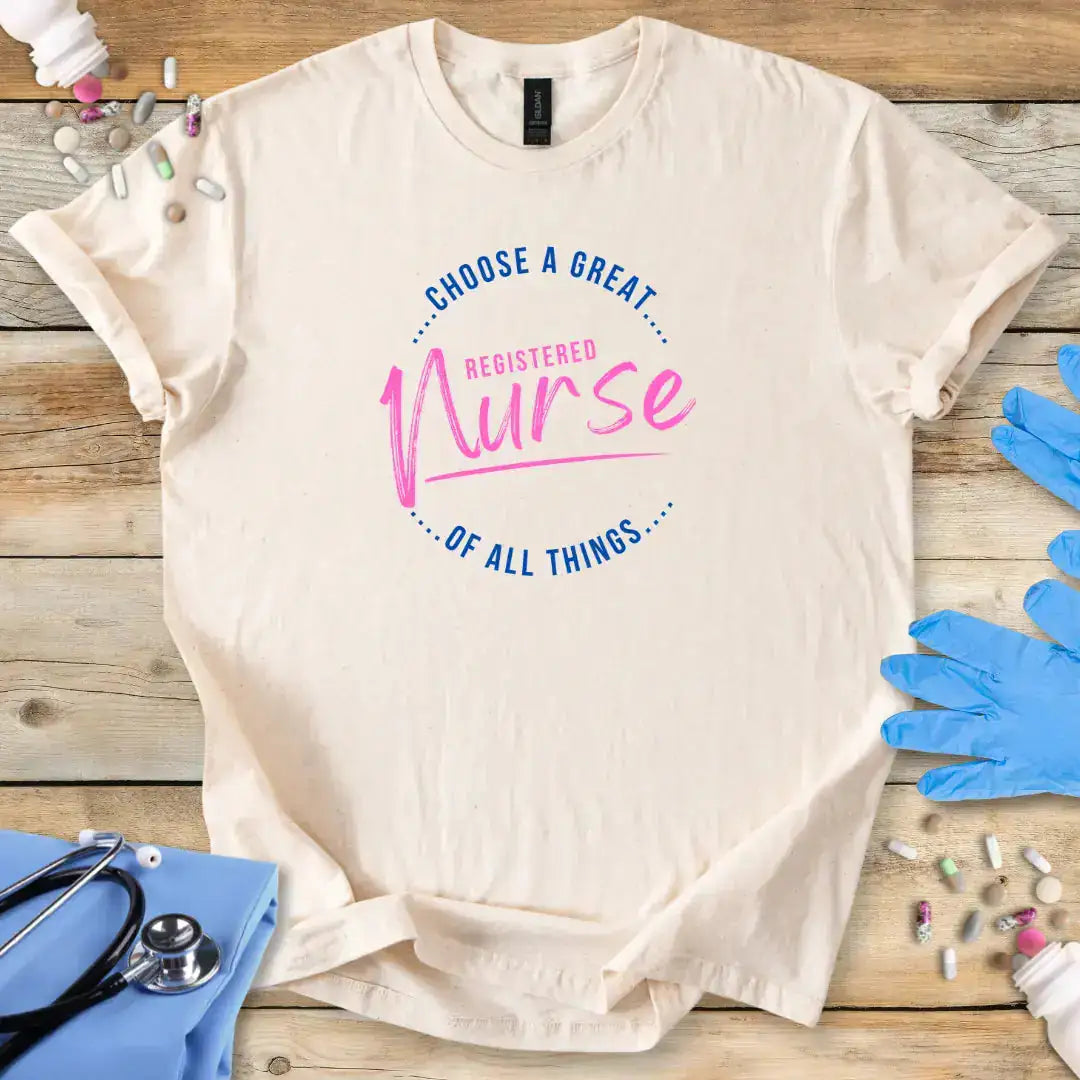Beige t-shirt with 'Choose a great registered nurse of all things' text on a wooden surface with medical accessories.