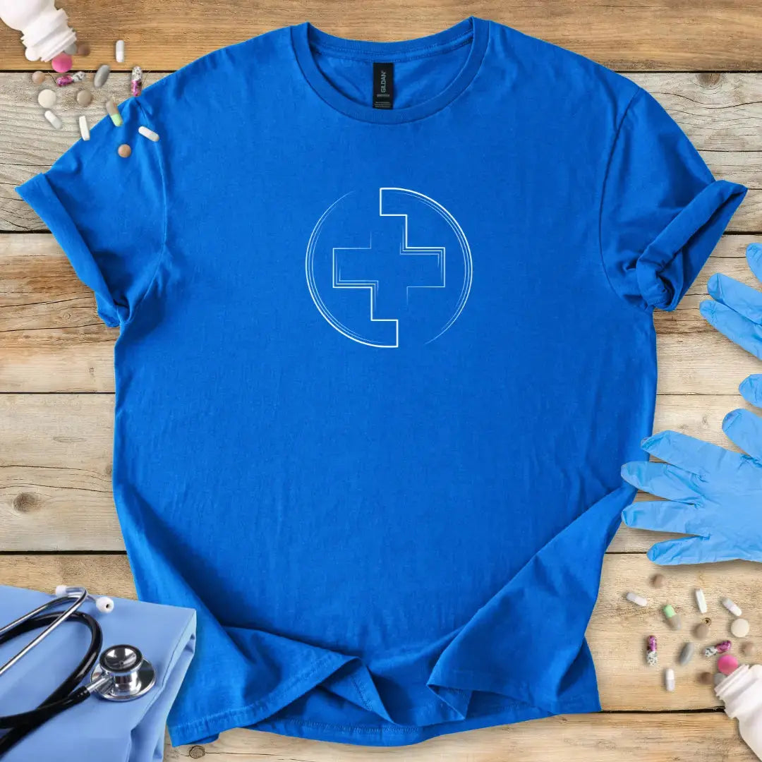 Royal Blue medic t-shirt with a white medical logo design on a wooden surface with medical items. 