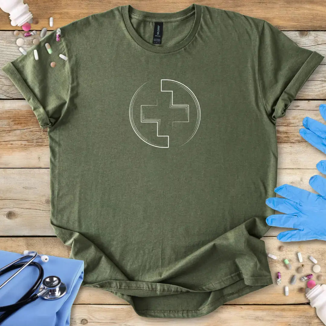Military Green Medical tactical t-shirt with a white medical cross design on a wooden surface with medical-themed items.