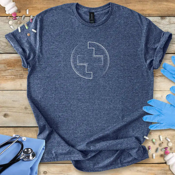 Blue t-shirt with a medical logo symbol on a wooden surface with gloves and medical supplies.