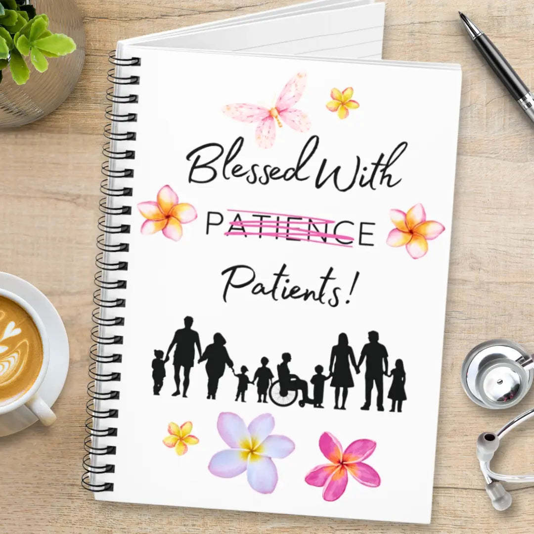 Spiral notebook with 'Blessed With Patients Not Patience' text on a wooden surface with a cup of coffee and stethoscope.