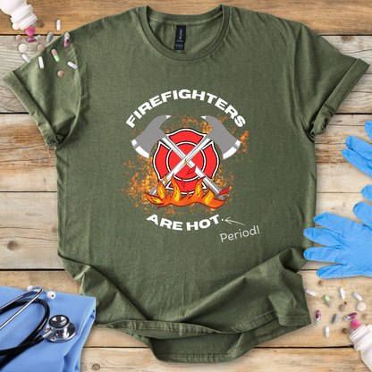 Military green t-shirt with firefighter graphic and text on a wooden surface with medical supplies.