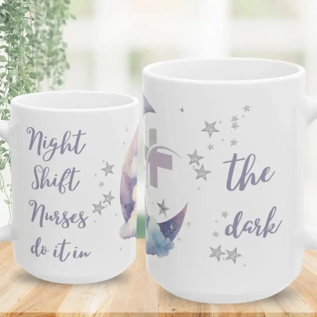 Two white mugs with star designs and text on a wooden surface.