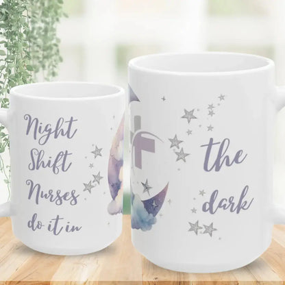 Two white mugs with star designs and text on a wooden surface.