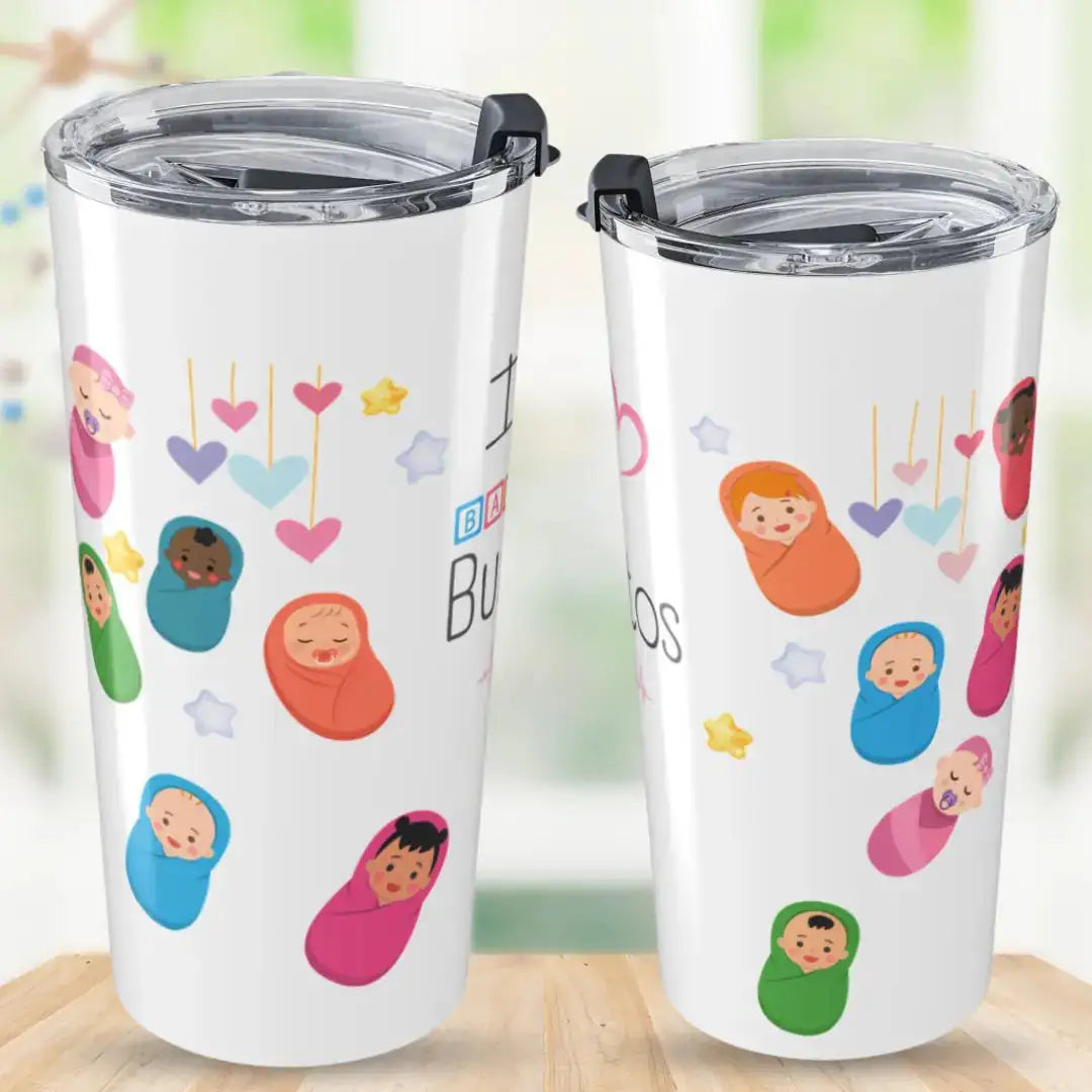 Two white stainless steel tumblers showing front and back views with 'I Love Baby Burritos' text, covered in colorful swaddled baby illustrations, hanging hearts, and star graphics, on a blurred green background.