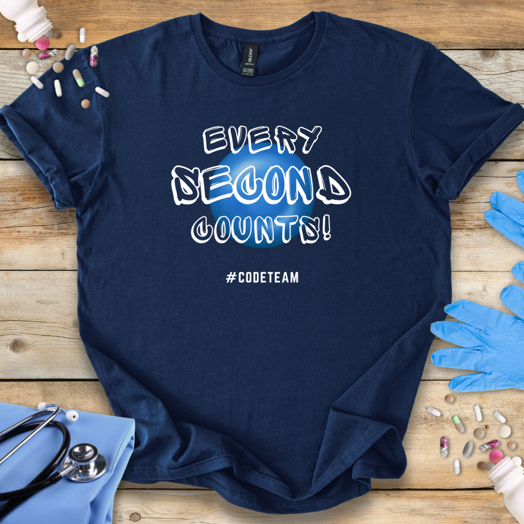 Navy blue t-shirt with 'Every Second Counts! #CODETEAM' text on a wooden surface with medical supplies.
