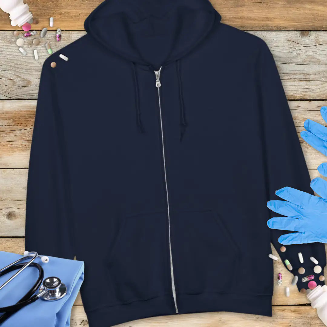 Navy blue zip-up hoodie front view with no print, displayed flat on a wooden background with stethoscope and medical gloves