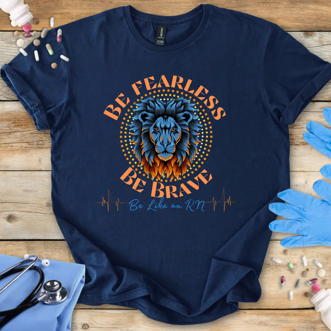 Navy blue t-shirt with lion graphic and 'Be Fearless Be Brave Like an RN' text on a wooden surface with medical supplies.