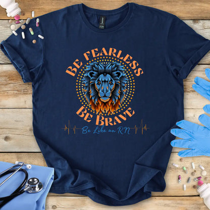 Navy blue t-shirt with lion graphic and 'Be Fearless Be Brave Like an RN' text on a wooden surface with medical supplies.