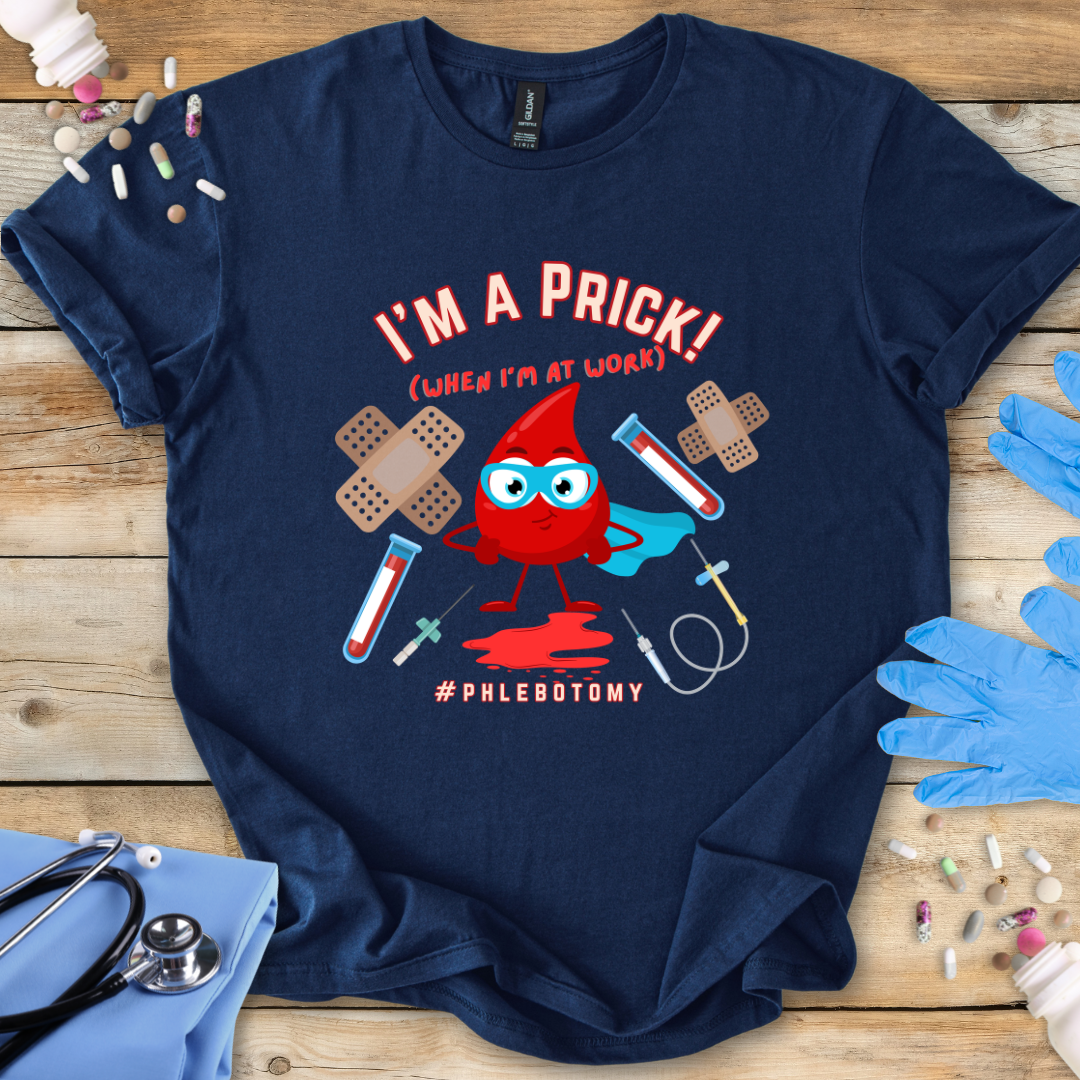 Navy t-shirt with a graphic design featuring a blood drop character and text 'I'm A Prick Phlebotomy' on a wooden surface with medical accessories.