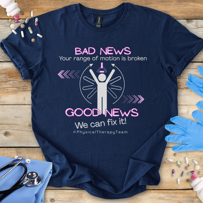 Navy blue t-shirt with physical therapy-themed design 'Your range of motion is broken' text on a wooden surface with gloves and stethoscope.