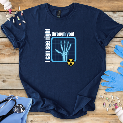 Navy blue med t-shirt with medical-themed graphic on a wooden surface with medical accessories.