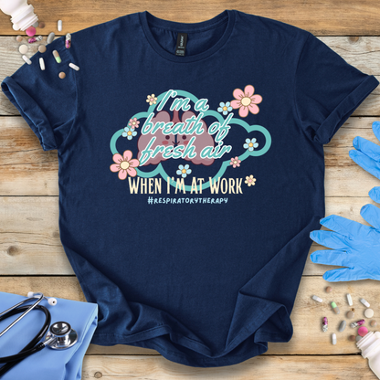 Navy blue t-shirt with respiratory therapy-themed design on a wooden surface with gloves and stethoscope.