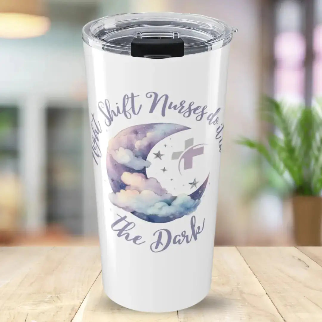 White stainless steel tumbler with 'Night Shift Nurses Do It In The Dark' in purple script, centered around a watercolor crescent moon with soft pastel clouds and silver star accents, on a blurred home background.