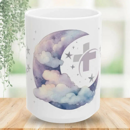 White mug with a celestial design featuring a moon, stars, and clouds on a wooden surface.