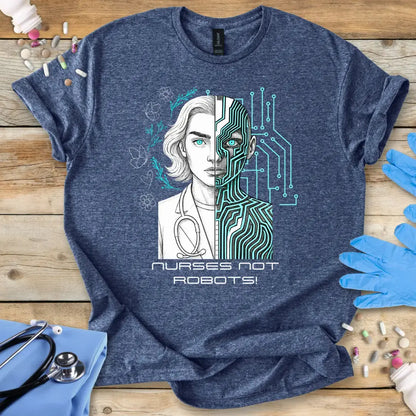 Blue t-shirt with a graphic design of a nurse and robot split in half, with text 'Nurses Not Robots!' on a wooden surface.