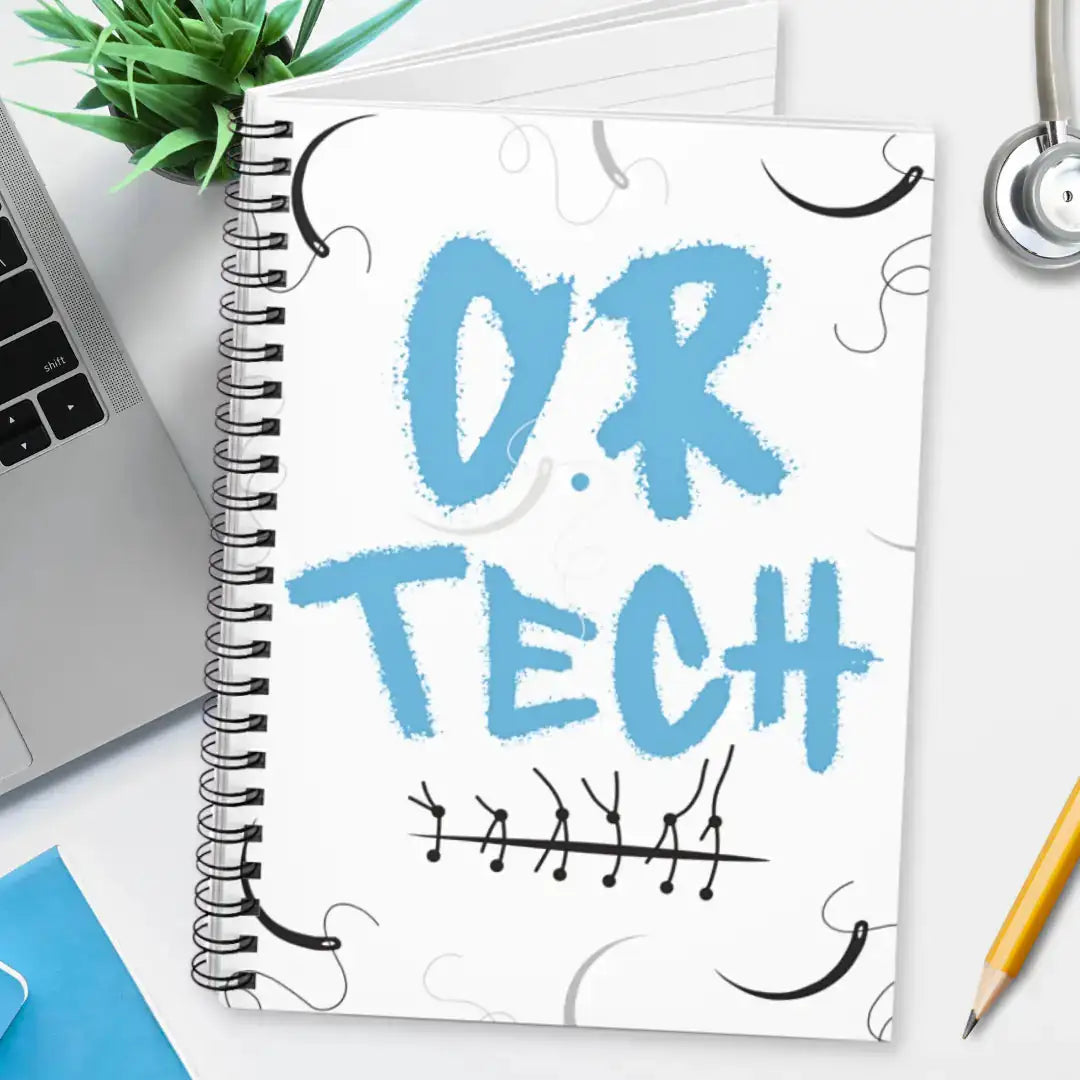 Spiral notebook with 'O.R. Tech' on a desk with a laptop and stethoscope.