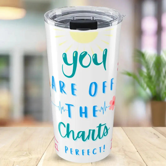 Tumbler with motivational quote 'You are off the charts' on a wooden surface