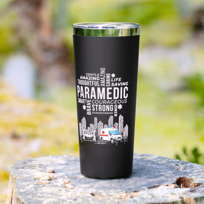 Black tumbler with white text and paramedic design on a natural background