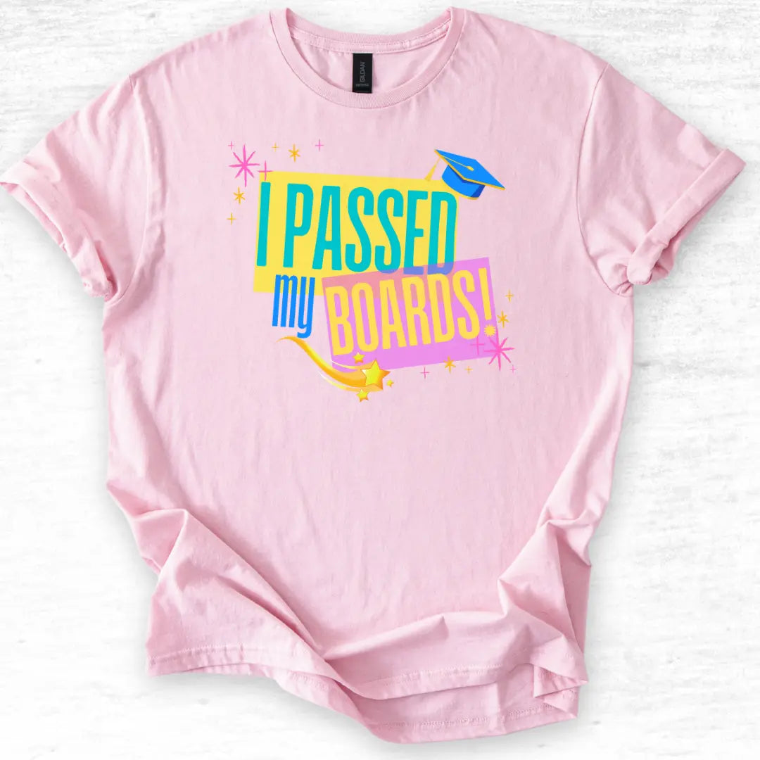 Pink t-shirt with 'I Passed My Boards!' text on a light gray background