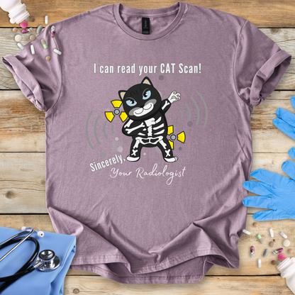 Paragon t-shirt with cartoon cat in an x-ray and 'I can read your cat scan your radiologist' text on a wooden surface with medical-themed props.