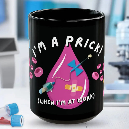 Black mug with a pink droplet graphic 'I'm A Prick When I'm At Work' and text in a laboratory setting