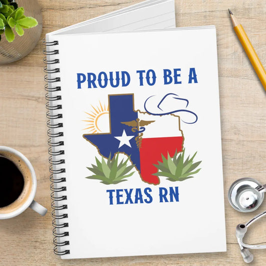 Notebook with 'Proud to be a Texas RN' design on a desk with coffee, pencil, and stethoscope.