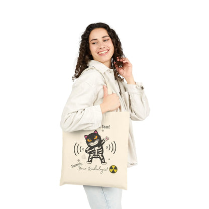 Woman holding a tote bag with a cat design and text on a white background