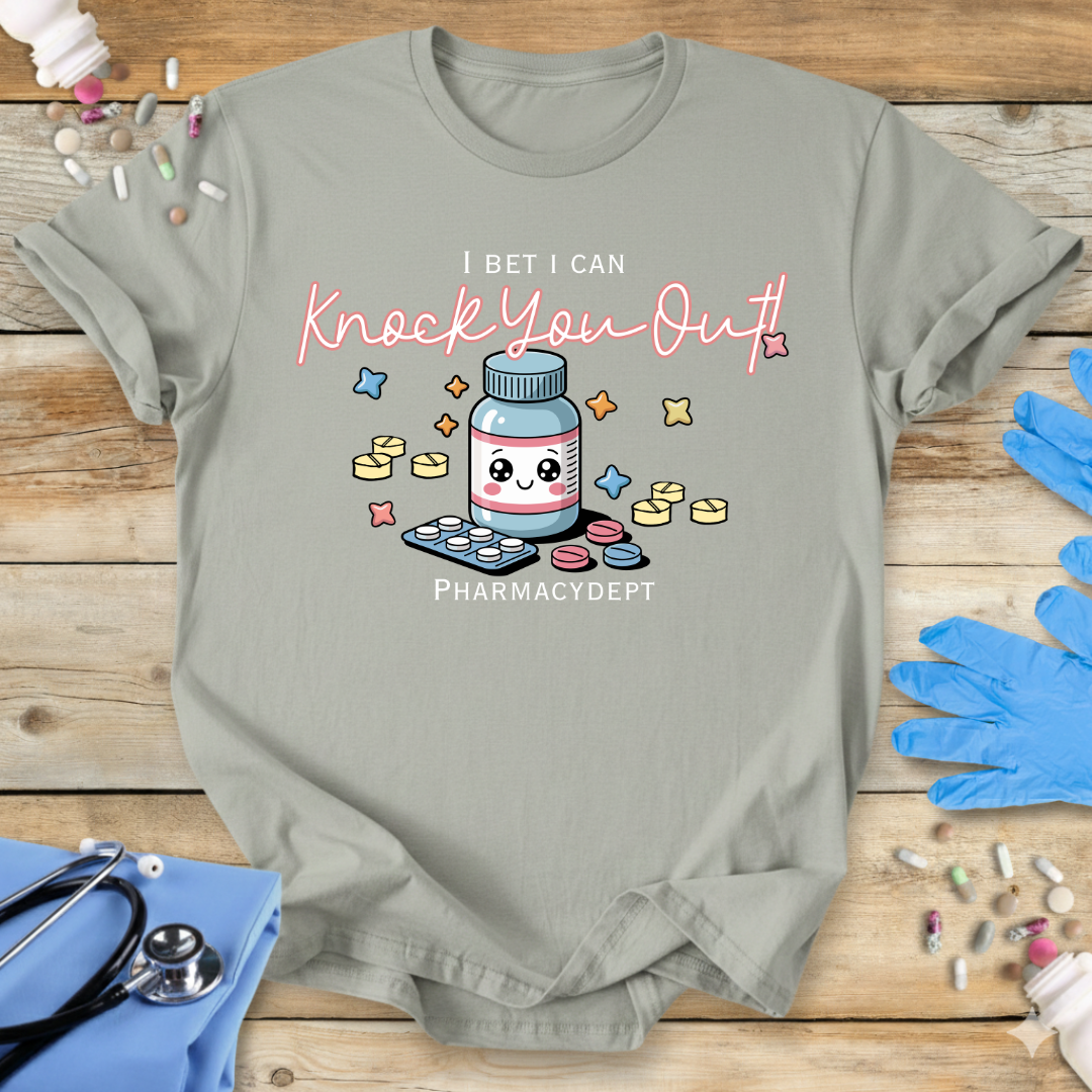 Sage med t-shirt with a pharmacy-themed graphic and 'I bet I can knock you out' text on a wooden surface with medical accessories.