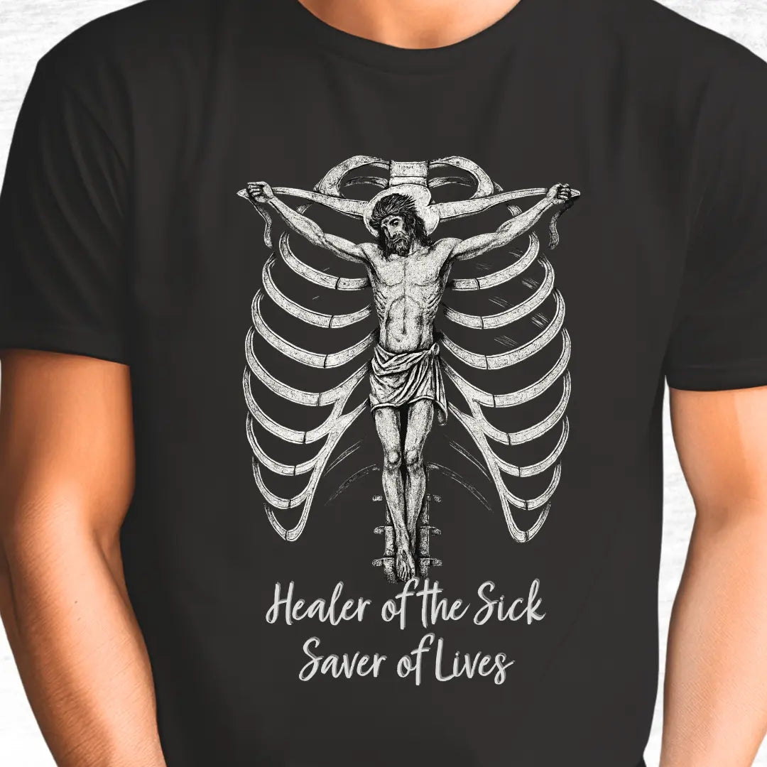 Black t-shirt with a graphic of Jesus and text 'Healer of the Sick, Saver of Lives' text on a white background.