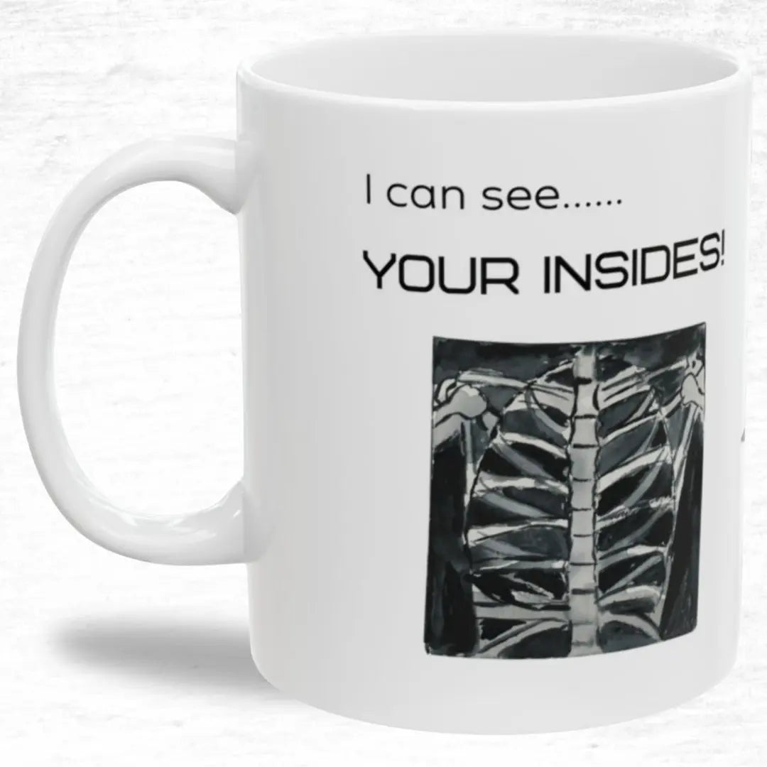 White mug with black text 'I Can See Your Insides' and a rib cage illustration on a white background