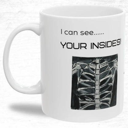 White mug with black text 'I Can See Your Insides' and a rib cage illustration on a white background