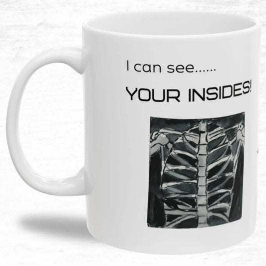 White mug with black text 'I Can See Your Insides' and a rib cage illustration on a white background