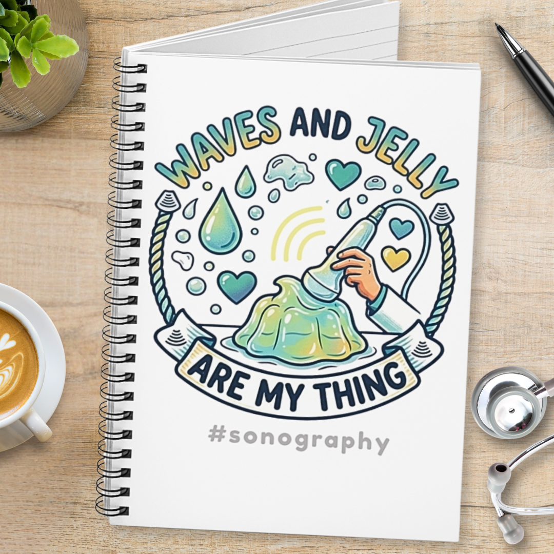 Notebook with 'Waves and Jelly are my thing' design on a wooden surface with a cup of coffee and stethoscope.