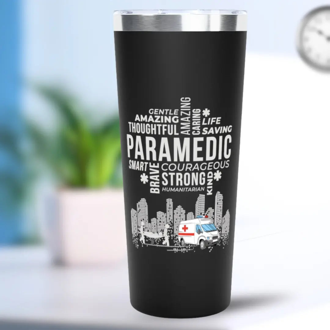 Black tumbler with white text 'Paramedic' and an ambulance graphic on a blurred background