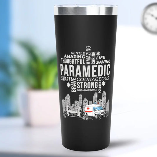 Black tumbler with white text 'Paramedic' and an ambulance graphic on a blurred background