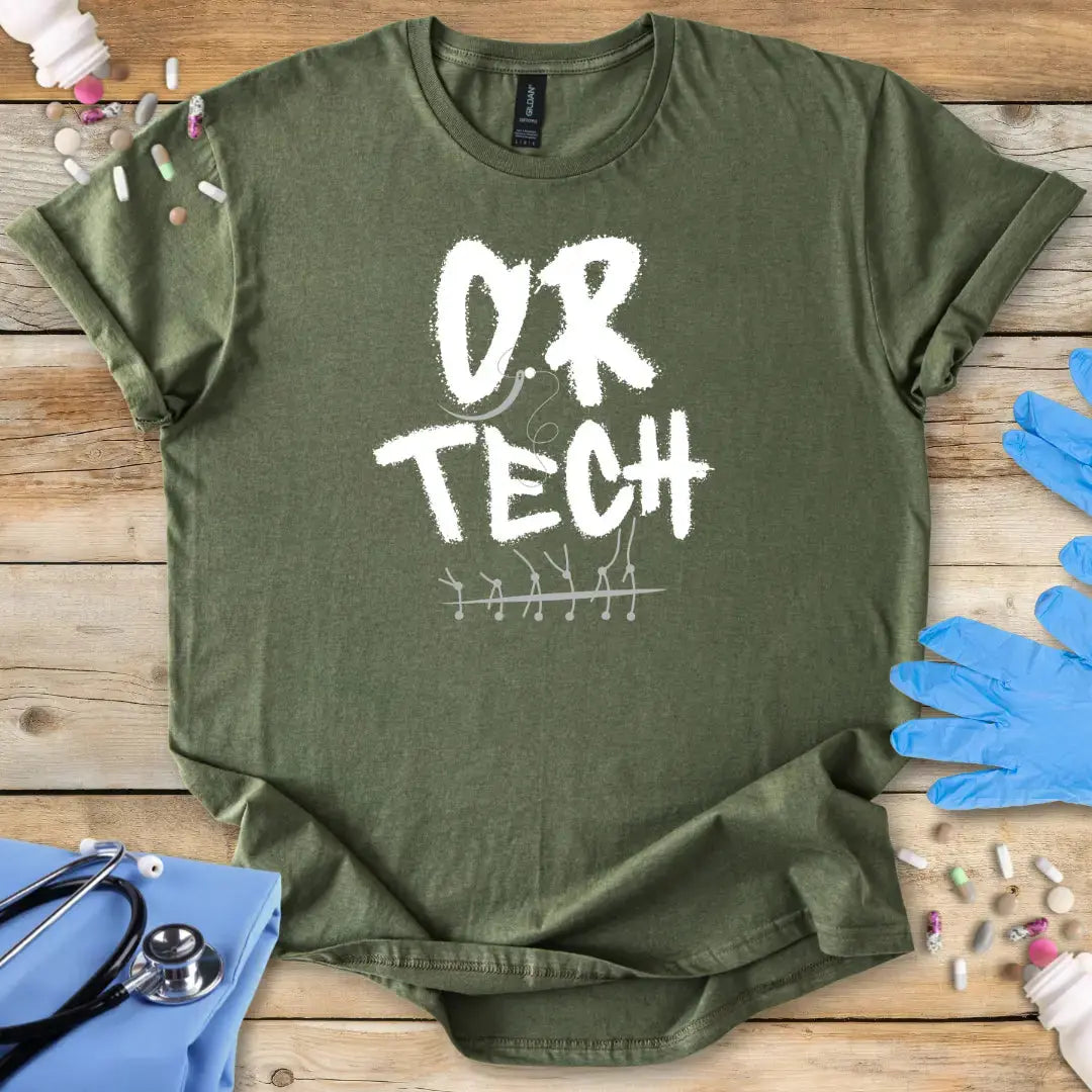 Green t-shirt with 'OR TECH' print on a wooden surface with medical supplies.