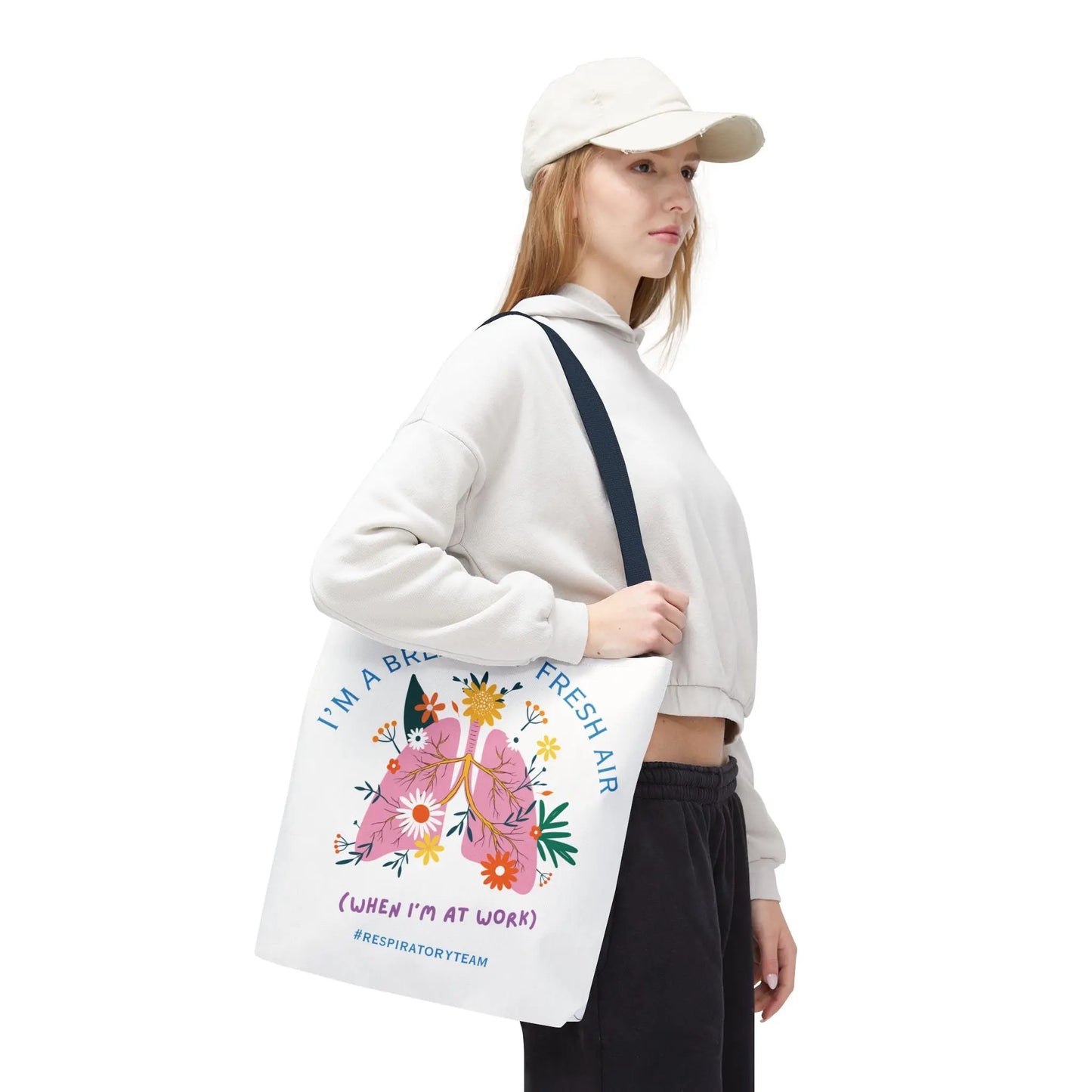 Woman holding a tote bag with floral design and "Respiratory Team" text on a white background