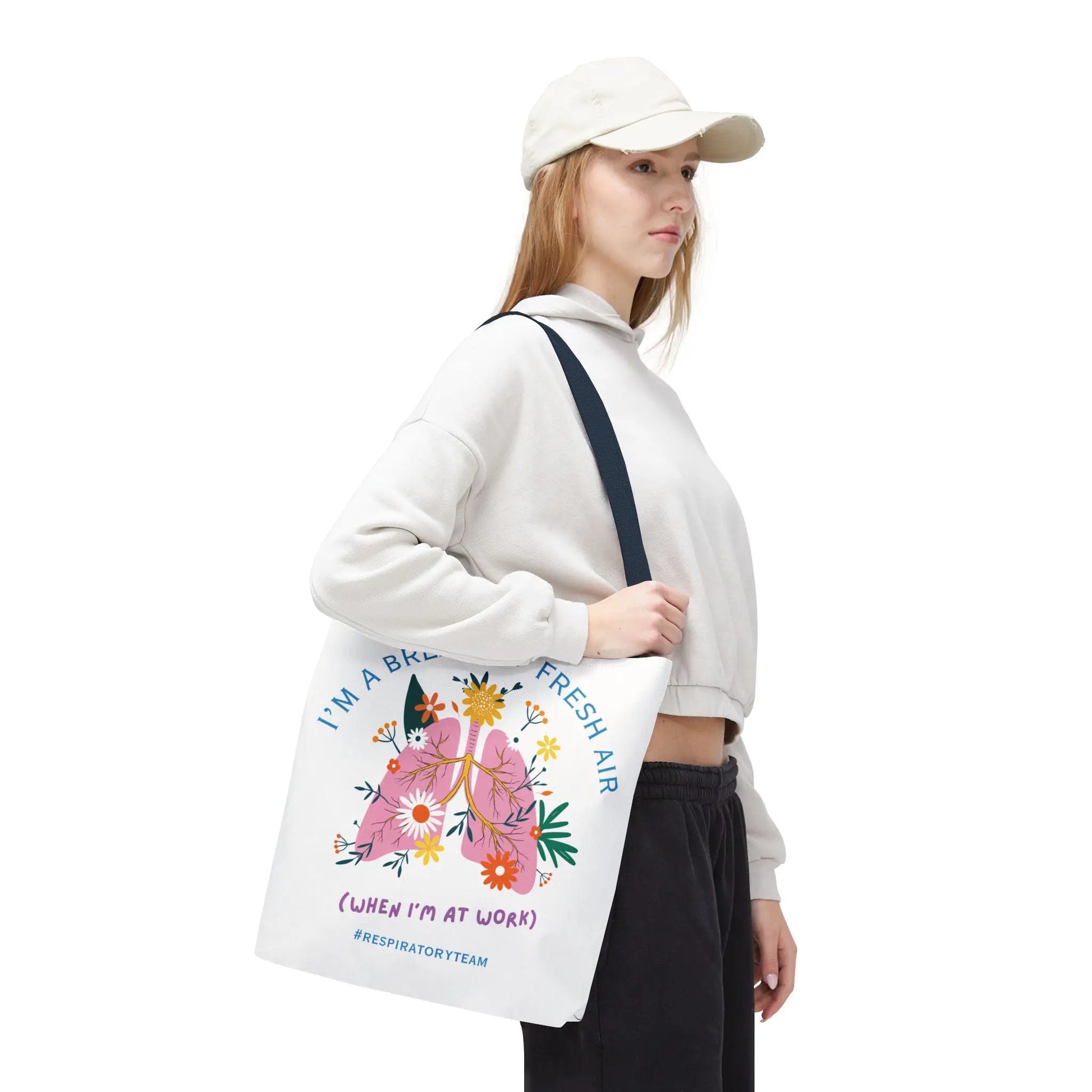 Woman holding a tote bag with floral design and "Respiratory Team" text on a white background