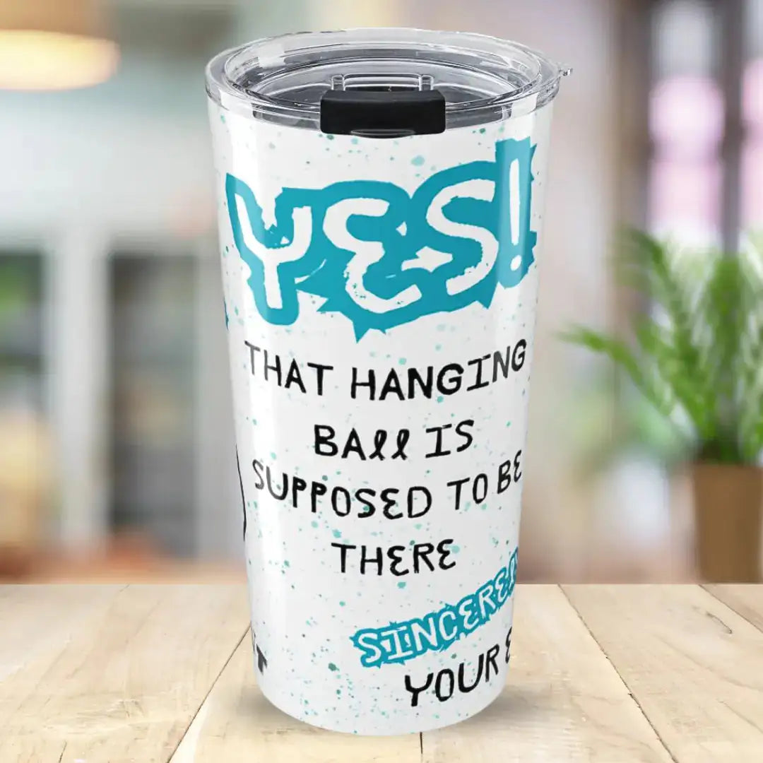 Tumbler with humorous text 'Yes, that hanging ball is supposed to be there, Uvula' design on a wooden surface