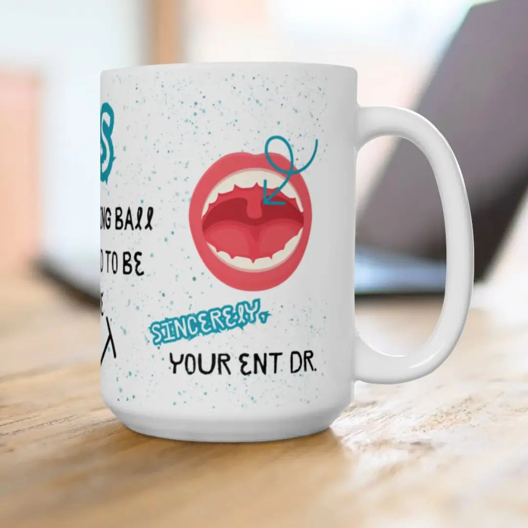 White mug with a graphic of a mouth and 'ENT Dr.' text on a wooden surface