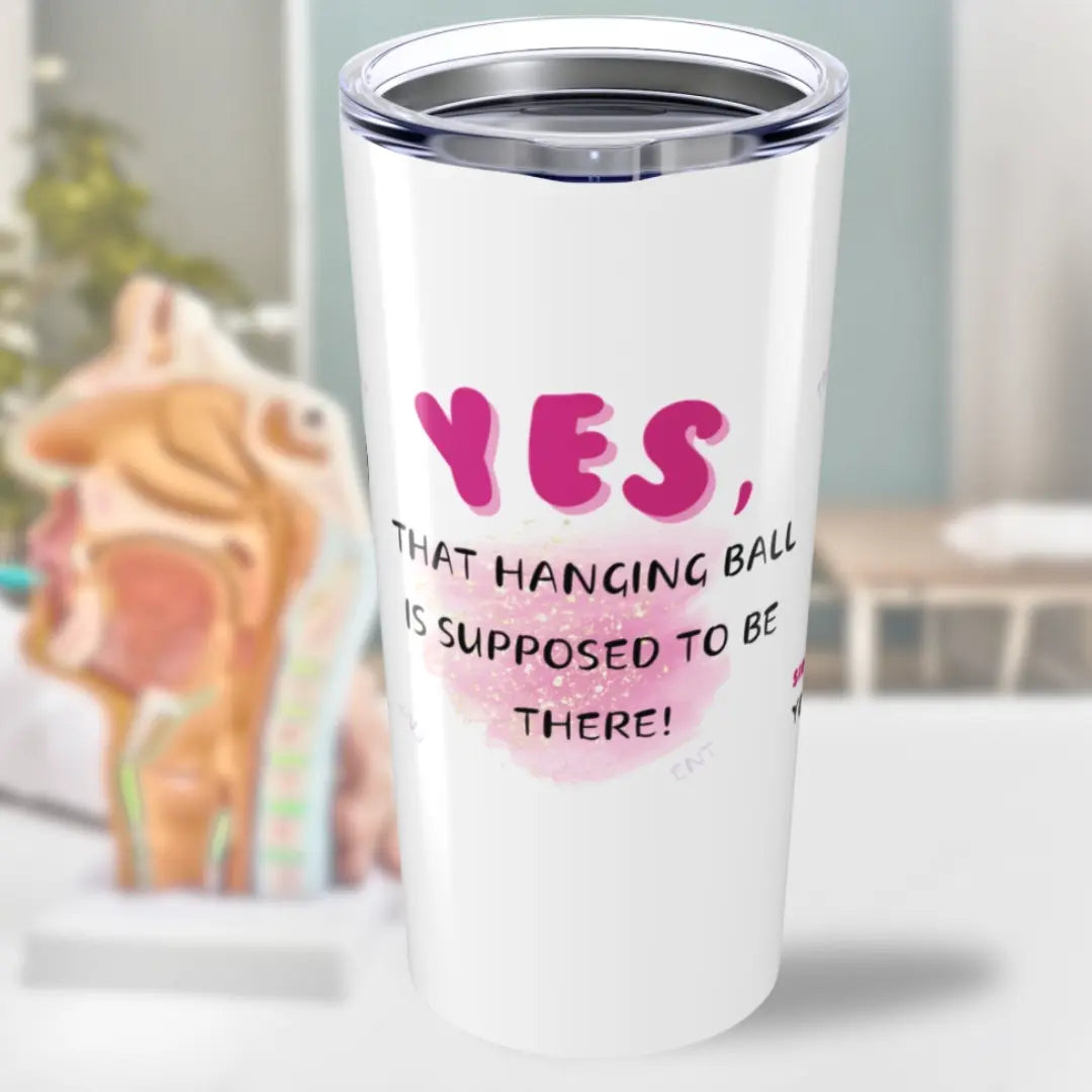 White tumbler with pink text 'Yes That Hanging Ball Is Supposed To Be There' and ENT design on a blurred background